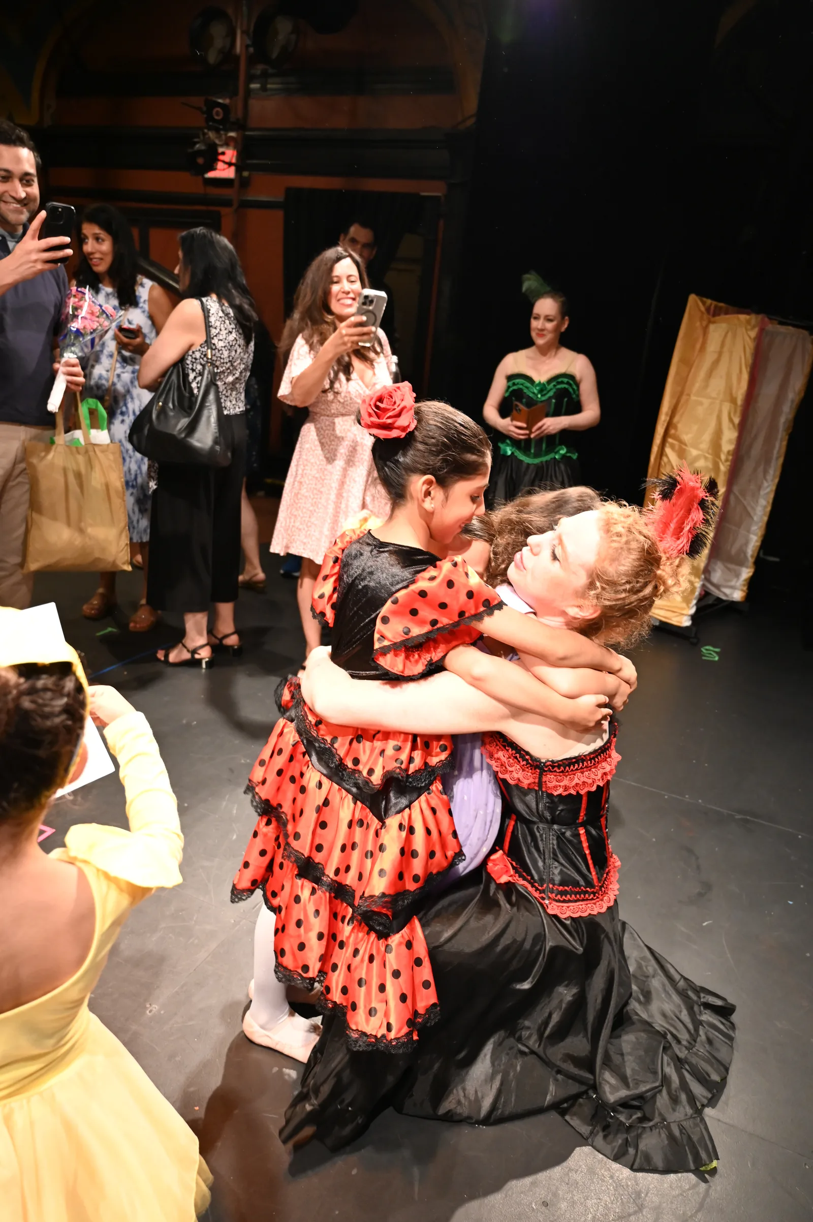 Teacher and student embracing after the curtain call